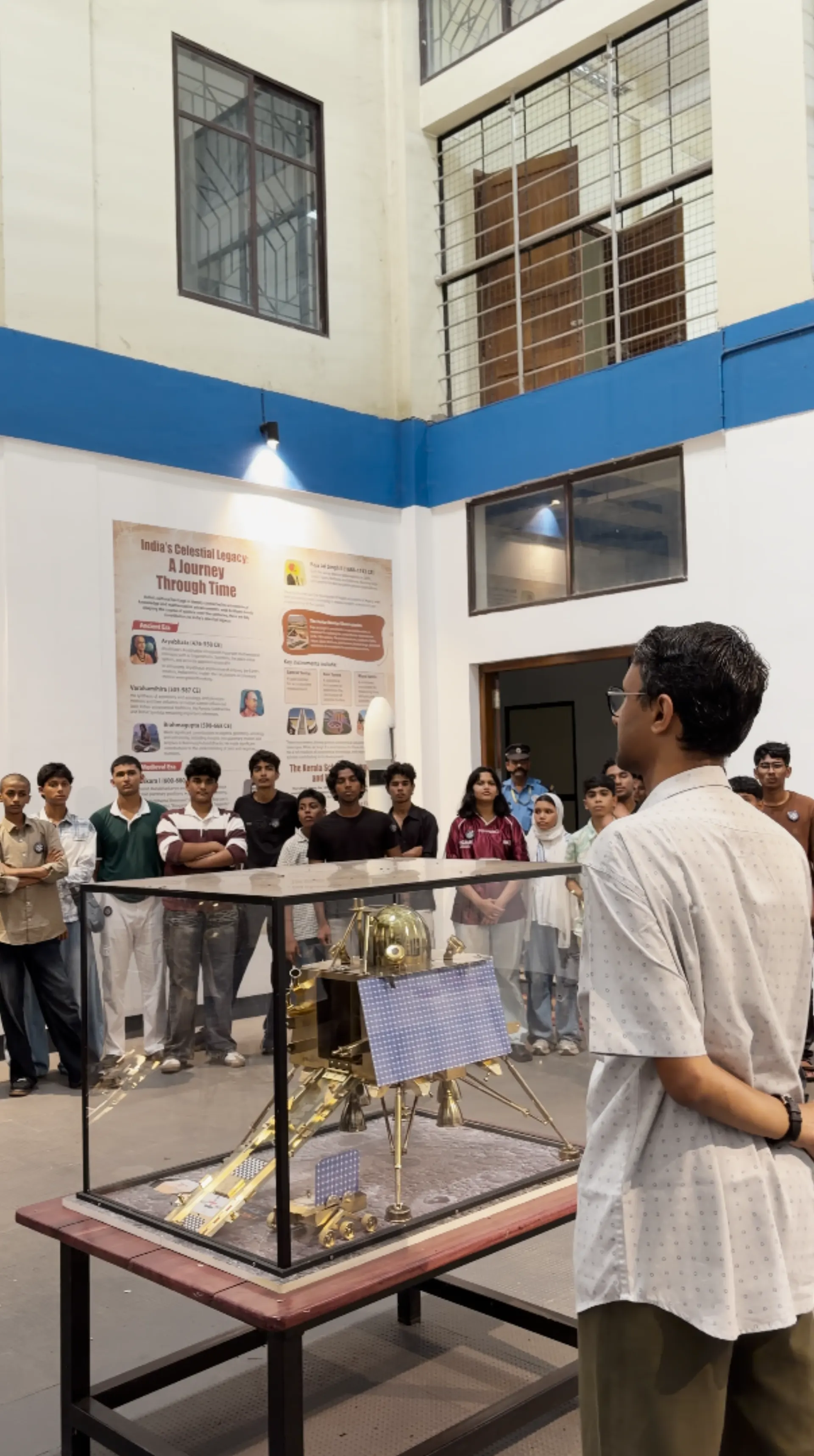 Mentor explaining a Chandrayaan lander model to students