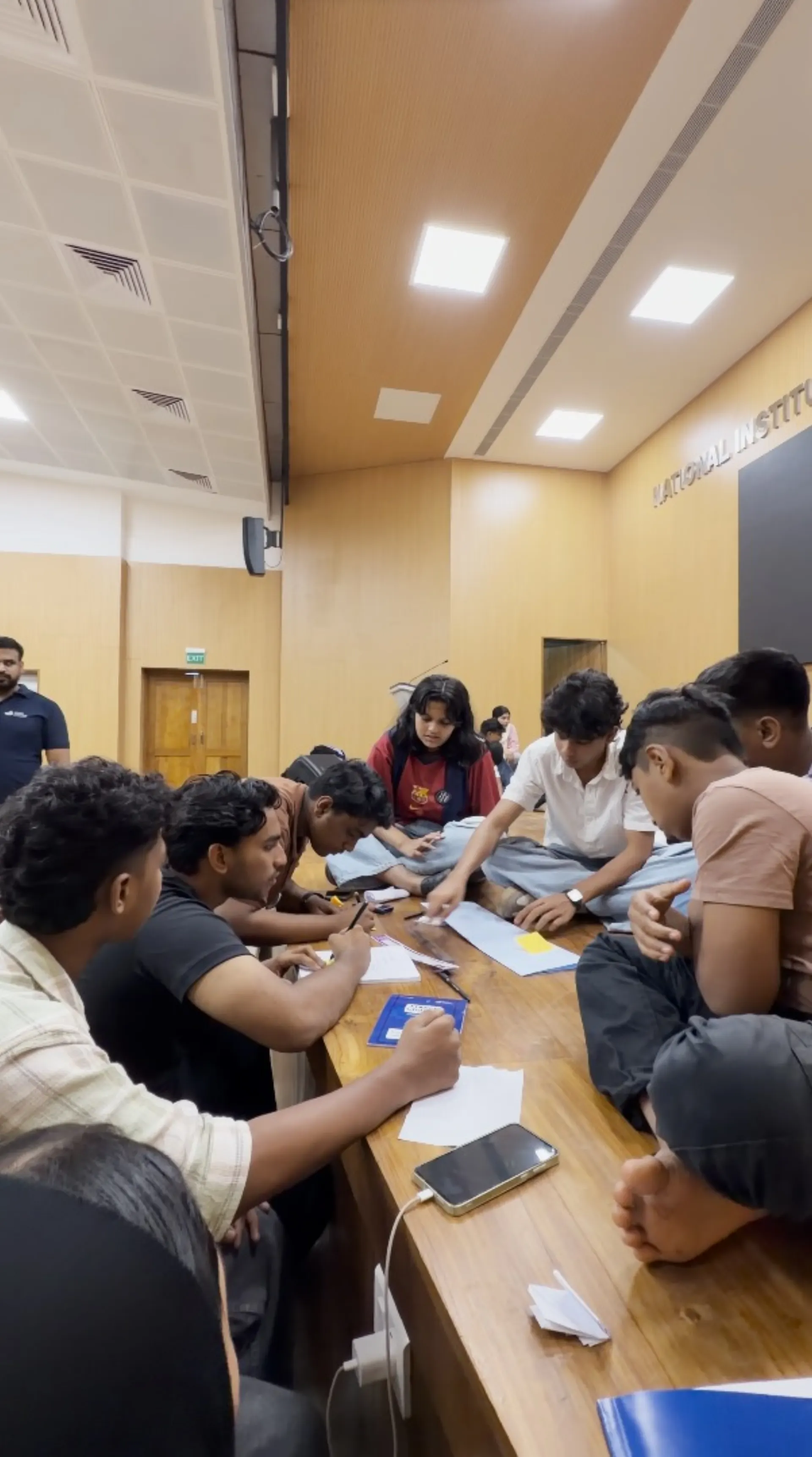 Team huddle inside an NIT Calicut hall
