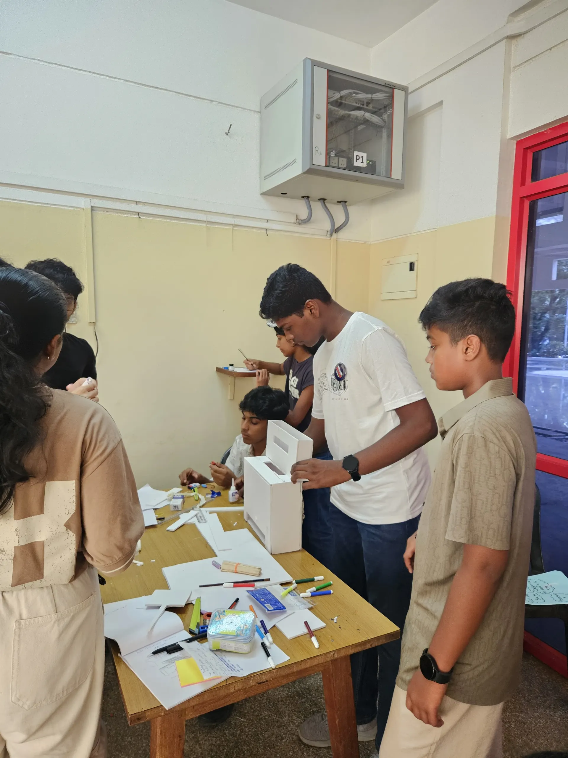 Students building a prototype with real materials